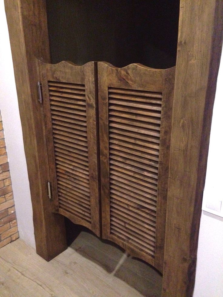 an open wooden cabinet with shutters on the front and side doors that are made out of wood