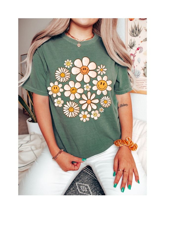 Step into the warmth of style and embrace the carefree vibes with our "Daisy Days Sunshine Bloom Tee." This delightful t-shirt is a celebration of the spirit of warmer days and sunny moments. Crafted from soft, breathable cotton, it provides comfort that matches its sunny disposition. The cheerful design features a vibrant daisy in full bloom, symbolizing the positivity and brightness that comes with the arrival of warmer weather. The playful colors and lively imagery make it a perfect addition Trendy Floral Print T-shirt For Day Out, Green Fun Tops For Day Out, Fun Green Tops For Day Out, Casual T-shirt With Daisy Print For Spring, Hippie Crew Neck T-shirt For Fall, Hippie Graphic Print Spring Top, Hippie Style Graphic Print Spring Tops, Hippie Graphic Print Tops For Spring, Hippie Tops With Graphic Print For Spring