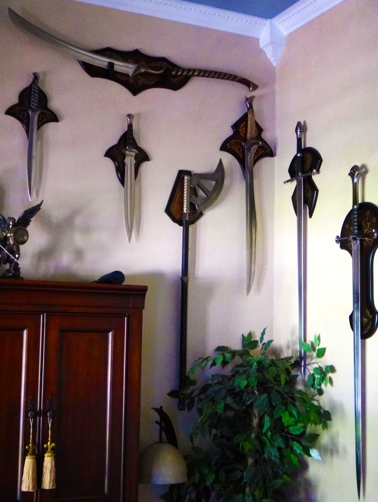 the wall is decorated with several different types of swords