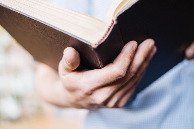 a person holding a book in their hands