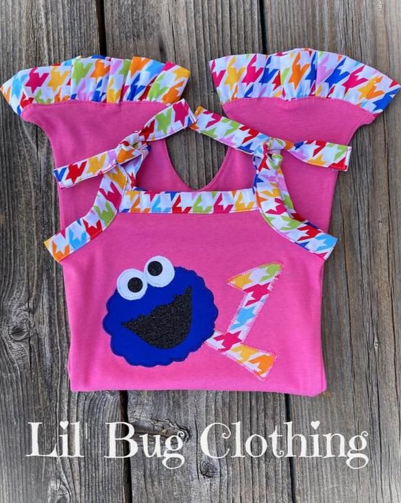 a pink bag with an elm street cookie monster applique on the front and bottom