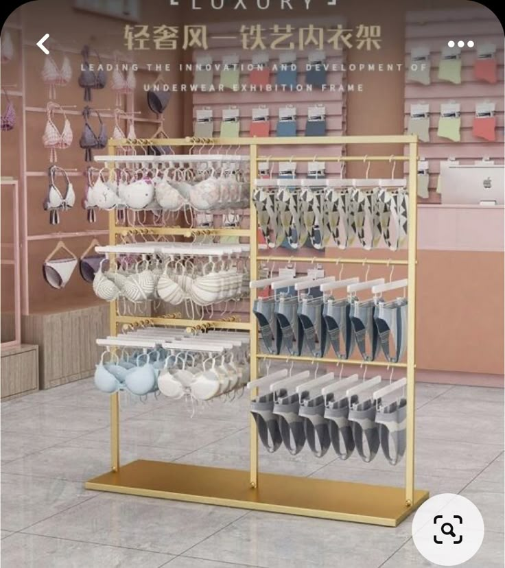 a display case filled with lots of white and blue dishes in front of a pink wall