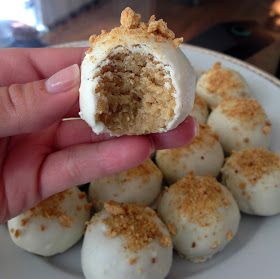 a hand holding a piece of food in it's palm over a white plate