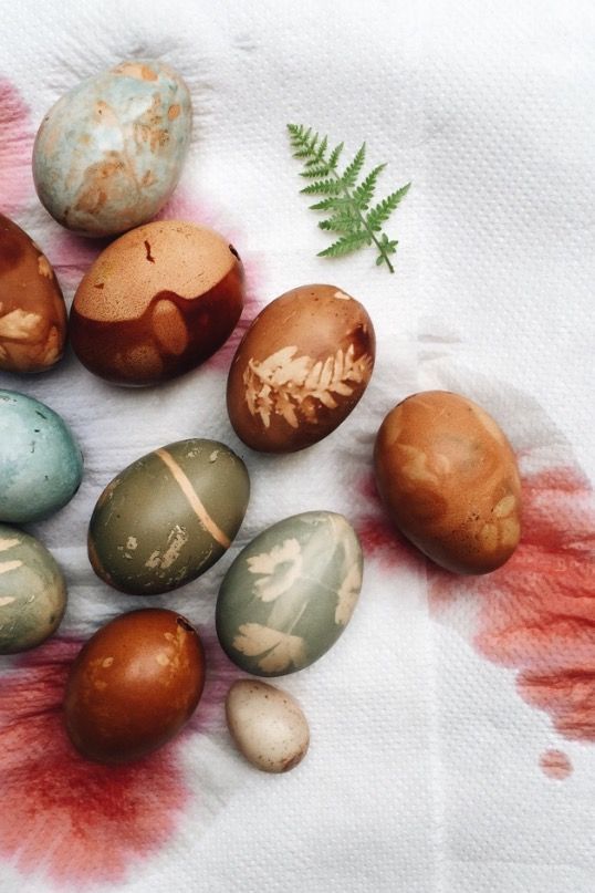 an arrangement of painted eggs on a napkin