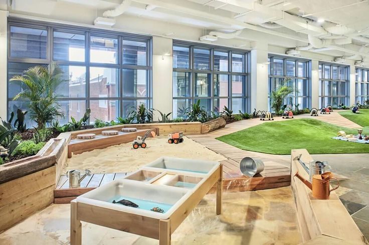 children's play area in an office building with lots of windows and toys on the ground