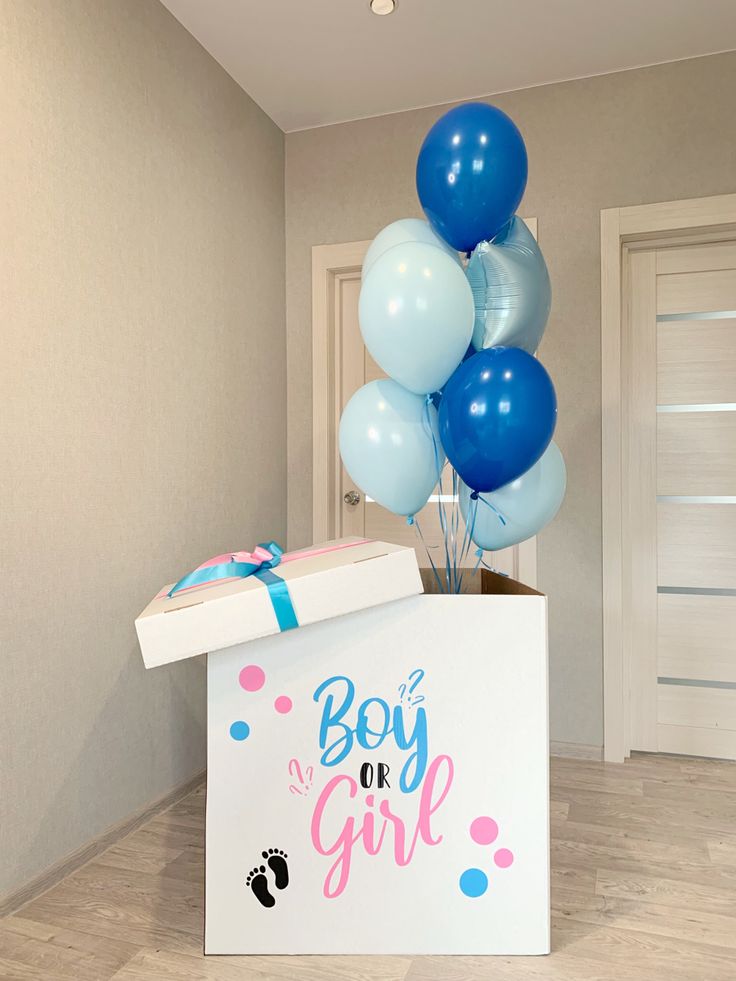 a boy or girl box with blue and white balloons