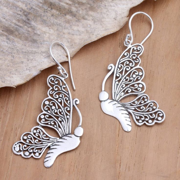 Intricately crafted, Budiharta's butterfly dangle earrings are a fine example of Balinese silversmithing. Artisans from the island nation use sterling silver to hand craft the earrings, twisting tendrils of the precious metal to form two openwork wings. Suspended from sterling silver hooks, these beauties are ready to soar. Silver Butterfly Jewelry For Pierced Ears, Silver Drop Earrings With Butterfly Charm, Sterling Silver Drop Earrings With Butterfly Charm, Sterling Silver Jewelry With Butterfly Charm Drop Earrings, Silver Butterfly Filigree Jewelry, Silver Filigree Butterfly Jewelry, Silver Butterfly Charm Drop Earrings, Silver Butterfly Earrings With Ear Wire, Nickel-free Butterfly Shaped Silver Earrings