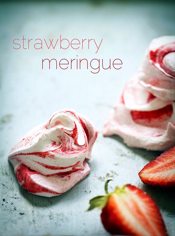 strawberry meringue is sitting next to two strawberries on a table with the words, strawberry meringue