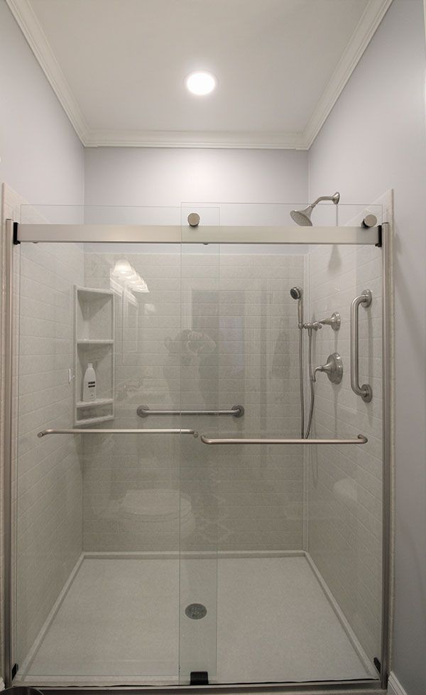 a walk in shower sitting next to a bathroom sink