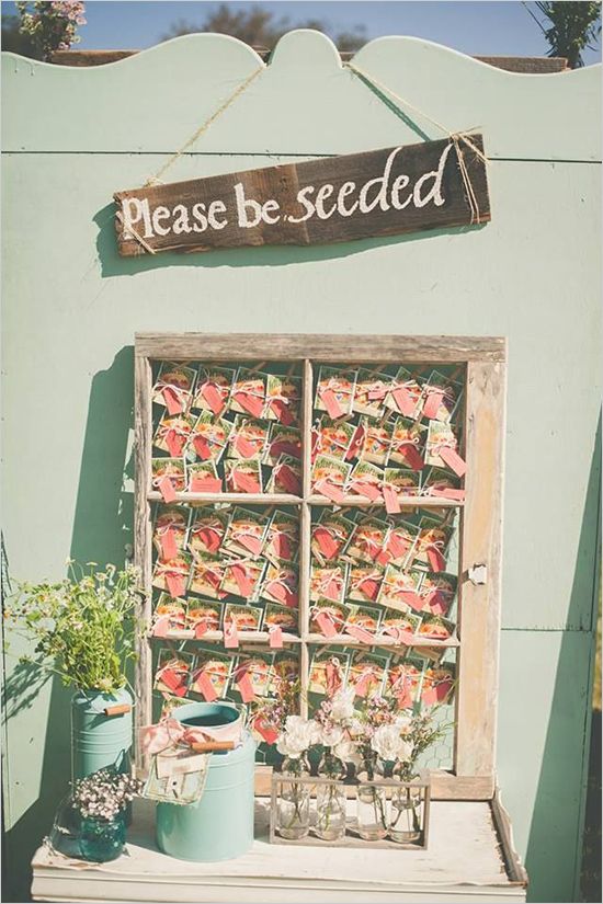 an old window is filled with flowers and seed packets for sale in front of a sign that says please be seeded