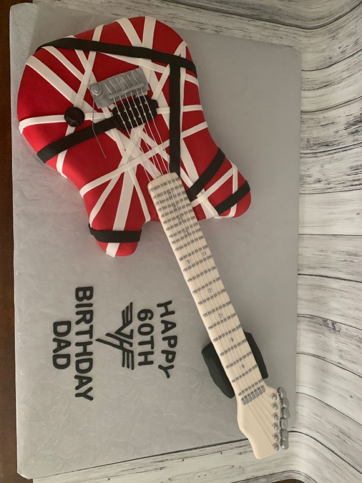 a cake shaped like an electric guitar with the british flag on it