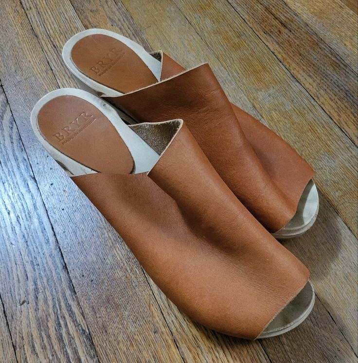 Slip On Bryr Clogs In Brown Leather With A Wooden High Heel. Love These But I Don't Wear Heels Anymore! Size 40. Brown Mules With Leather Footbed And Wedge Heel, Leather Mules With Stacked Wedge Heel, Brown Leather Wedge Heel Mules, Brown Leather Mules With Block Heel, Chic Brown Leather Clogs, Brown Leather Footbed Mules With Open Heel, Brown Open Heel Mules With Leather Footbed, Brown Leather Sole Wedge Clogs, Brown Wedge Heel Clogs With Leather Sole