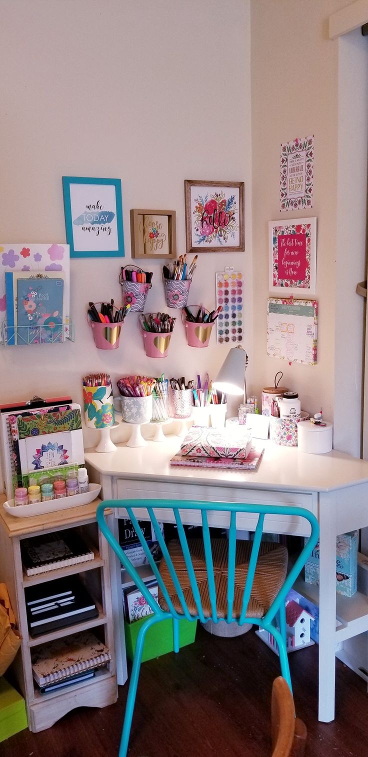 a white desk topped with lots of crafting supplies on top of a hard wood floor