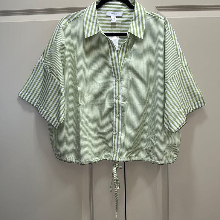 New Forever 21 Striped Shirt, Size 3x, Never Worn, Tags Still Attached, Colors Include Green & White, Button Down Shirt With String At Bottom For Option To Adjust At Waist, Has A Collar, 100% Cotton, Will Come From A Pet/Smoke Free Home Fyi, Can Be Cropped Based On Your Height Forever 21 Relaxed Fit Short Sleeve Tops, Forever 21 Relaxed Fit Tops For Spring, Forever 21 Shirt For Spring Day Out, Chic Green Top From Forever 21, Forever 21 Collared Summer Tops, Forever 21 Collared Tops For Summer, Forever 21 Green Tops For Spring, Forever 21 Summer Shirt For Day Out, Forever 21 Cotton Shirt For Spring