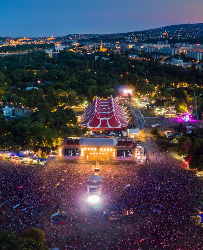 an aerial view of a concert in the middle of a city at night with lots of people