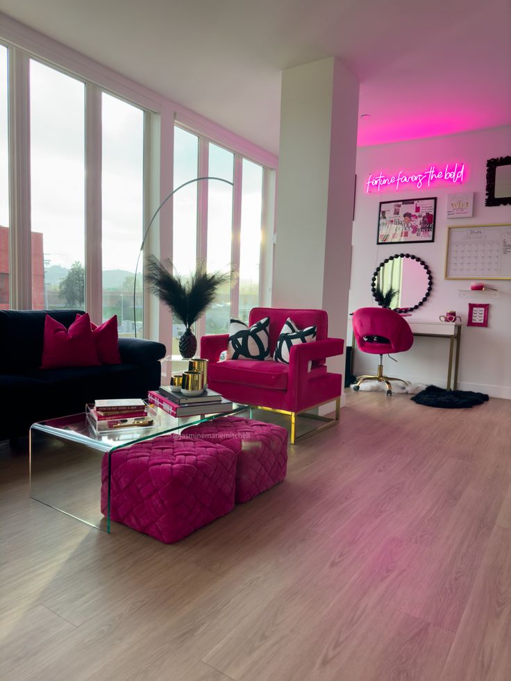 a living room with pink and black furniture