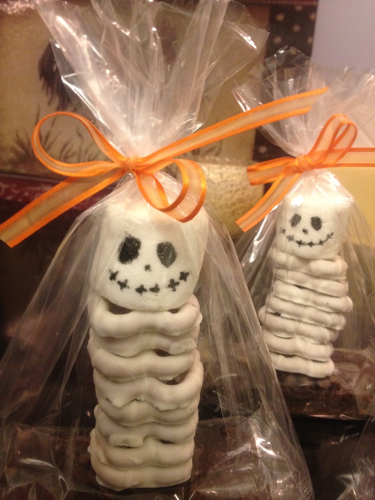 two skeleton cookies wrapped in plastic and tied with orange ribbon