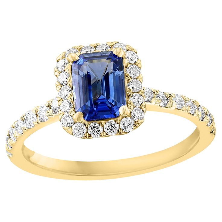 Showcases an emerald-cut blue sapphire weighing 1.06 carats, surrounded by a single row of 36 round brilliant diamonds in a seamless halo design. Set in a thin 14-karat yellow gold band accented with diamonds. Diamonds weigh 0.49 carats in total. Style is available in different price ranges. Prices are based on your selection of the 4C’s (Carat, Color, Clarity, Cut). Don't hesitate to get in touch with us for more information. Ruby Band Ring, Sapphire Diamond Engagement Ring, Diamond Sapphire Engagement Ring, Sapphire Diamond Engagement, Emerald Cut Diamond Engagement, Gold Solitaire Engagement Ring, Halo Design, Modern Engagement Rings, Engagement Ring Diamond Cut