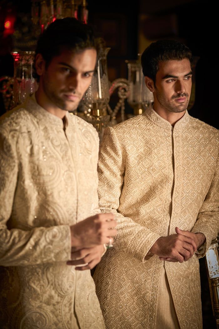 This set features thread embroidery in tonal colours highlighted with intricate pearls and beads. It is paired with matching silk kurta and light beige pants. Complimenting footwear is also available. DELIVERY TIMEPlease allow 8-12 weeks for your outfit to arrive. FABRIC DETAILSSherwani - Raw Silk, Kurta - Silk, Pant - Brocade Professional cleaning only. Short Sherwani, Raw Silk Kurta, Seema Gujral, Indian Groom Wear, Silk Pant, Silk Kurta, Indian Groom, Beige Pants, Sequin Embroidery