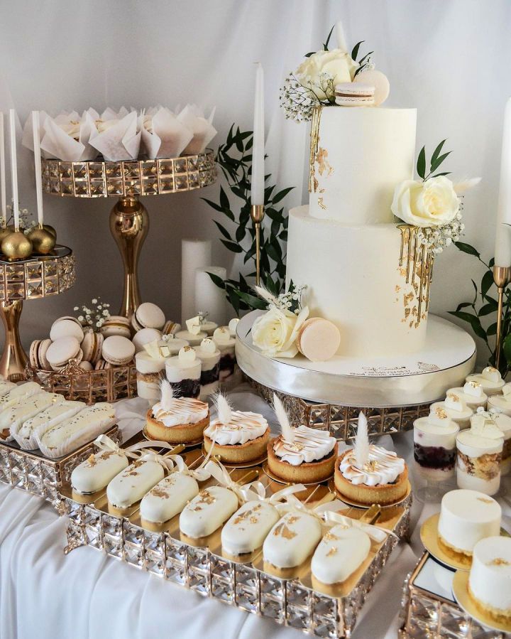 a table topped with lots of cakes and cupcakes