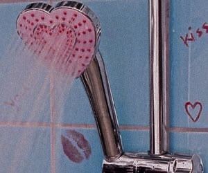 a shower head with two hearts attached to it