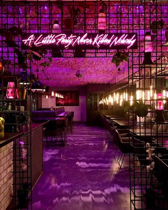 the inside of a restaurant with purple lighting