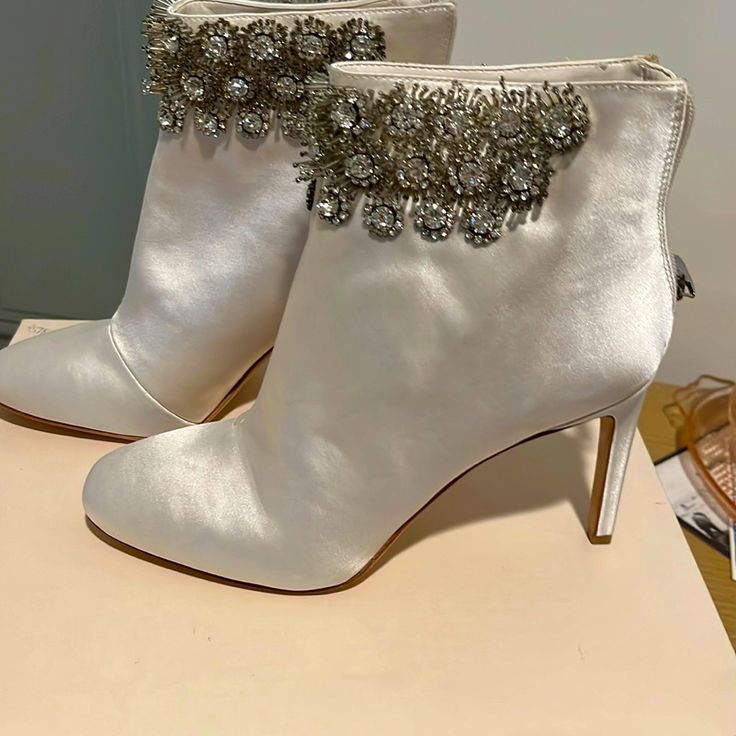 Ivory Satin Ankle Boots. Never Worn. Beautiful Crystal Embellishments Elegant White Party Boots, Elegant Ankle-high Embellished Heels, Elegant Embellished Ankle-high Heels, Elegant Wedding Boots Embellished, Elegant Embellished Wedding Boots, White Embellished Boots With Pointed Toe, Embellished Closed Toe Boots For Formal Occasions, Chic Embellished Cream Heels, Chic Cream Embellished Heels