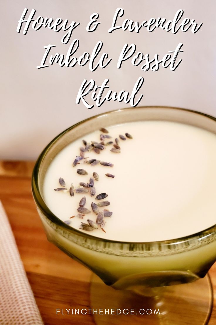 a glass bowl filled with milk and lavenders