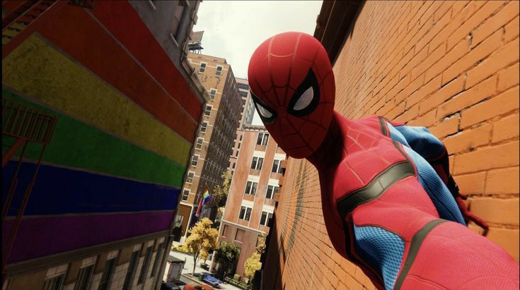 a spider man hanging from the side of a brick building in front of a city street