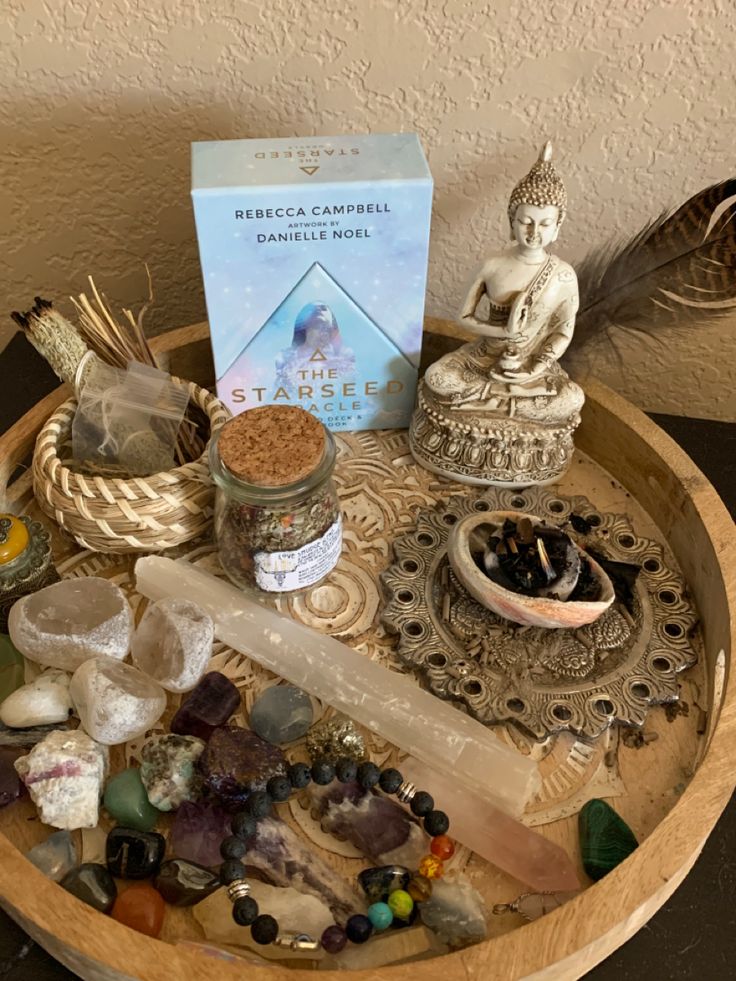 a wooden tray topped with lots of different types of stones and other things on top of it