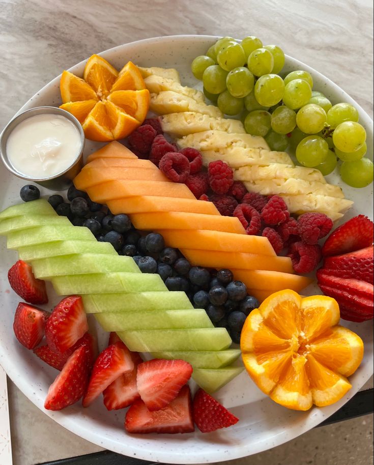 a white plate topped with fruits and vegetables