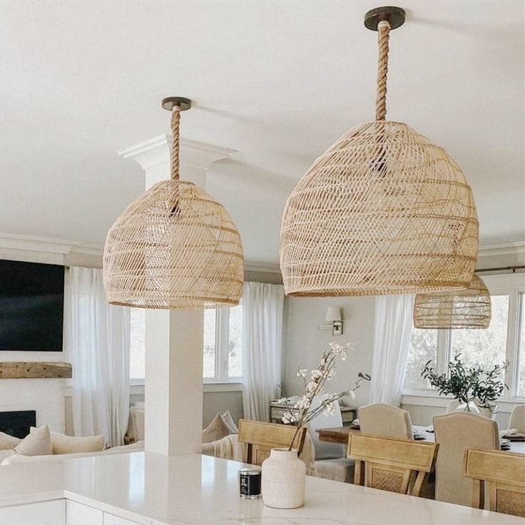 two wicker lamps hanging over a kitchen island