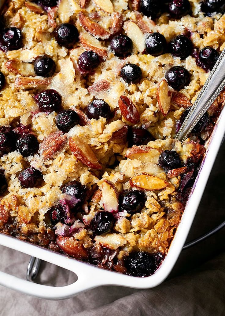 blueberry baked oatmeal in a white casserole dish with a spoon