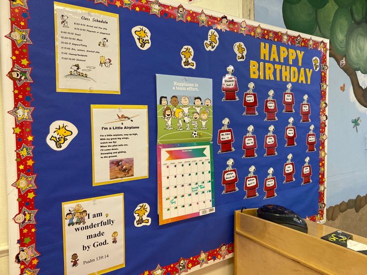 a bulletin board is decorated with sports related images and posters for children's birthdays