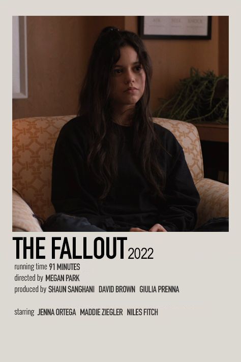 a woman sitting on top of a couch in front of a poster that says the fallout