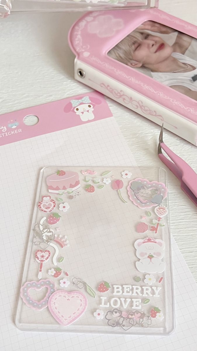 a baby's photo in a pink frame next to scissors