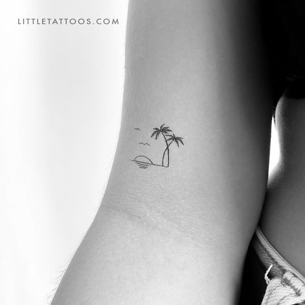 a small palm tree tattoo on the back of a woman's left arm,