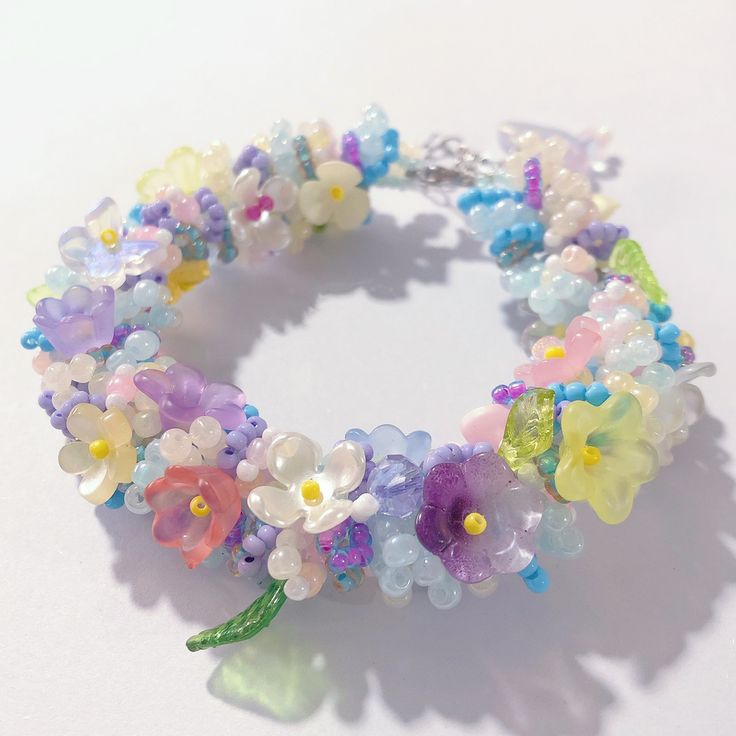 a bracelet with flowers and beads on it