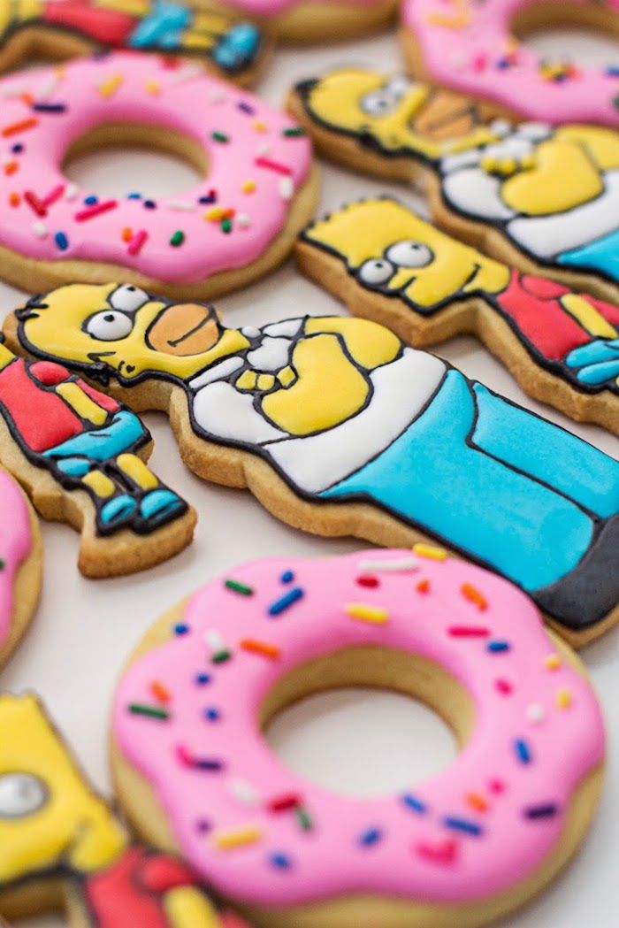 the simpsons characters are decorated with frosting and sprinkles on their cookies