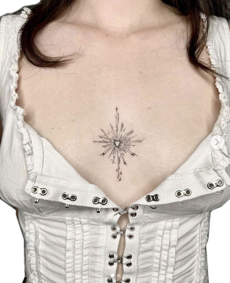 a woman's chest with a star tattoo on her left side and an arrow in the middle