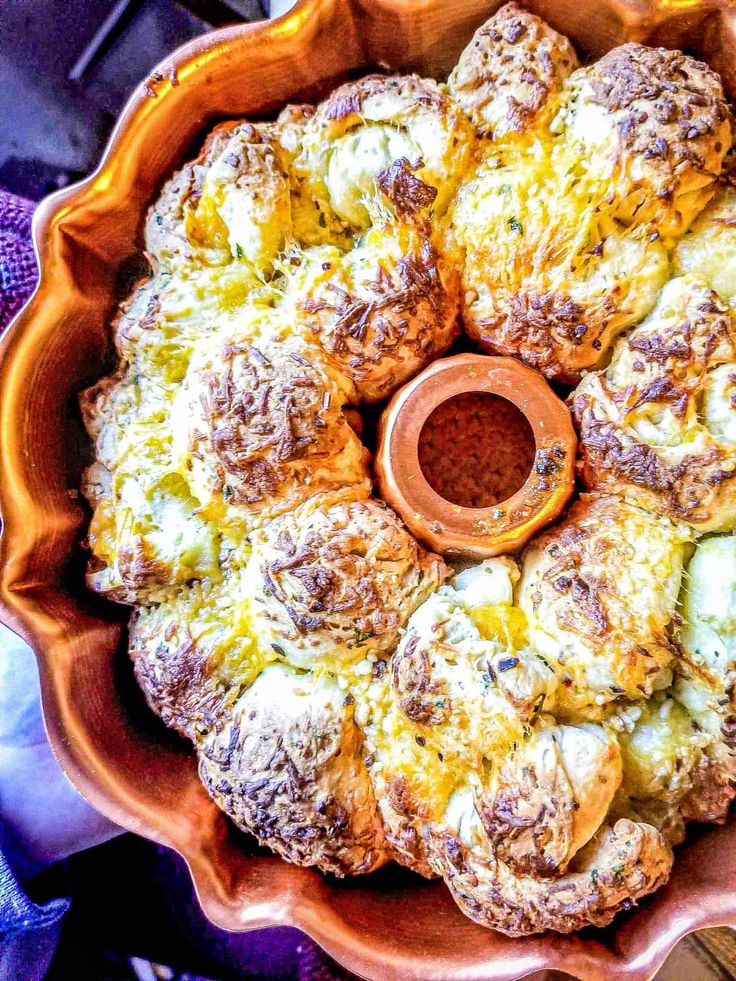 cheese stuffed garlic bread in an orange bowl with text overlay that reads, cheese stuffed garlic bread