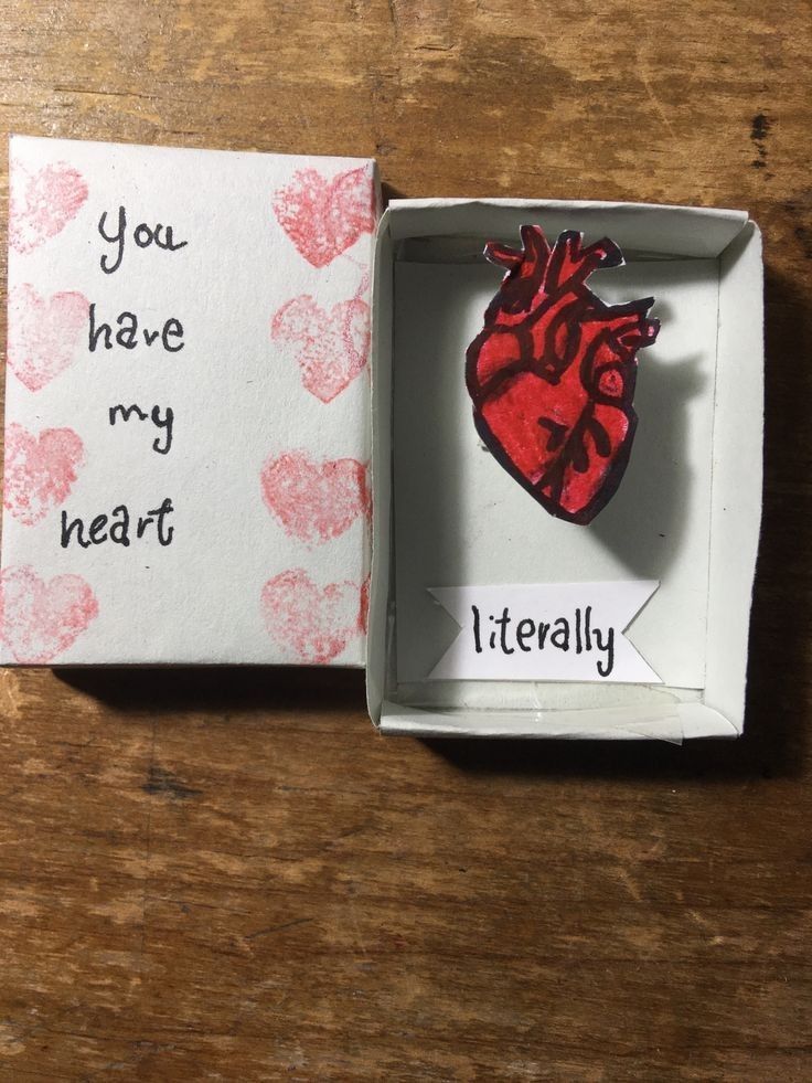 an open box with a red heart in it on a wooden table next to a piece of paper that says you have my heart