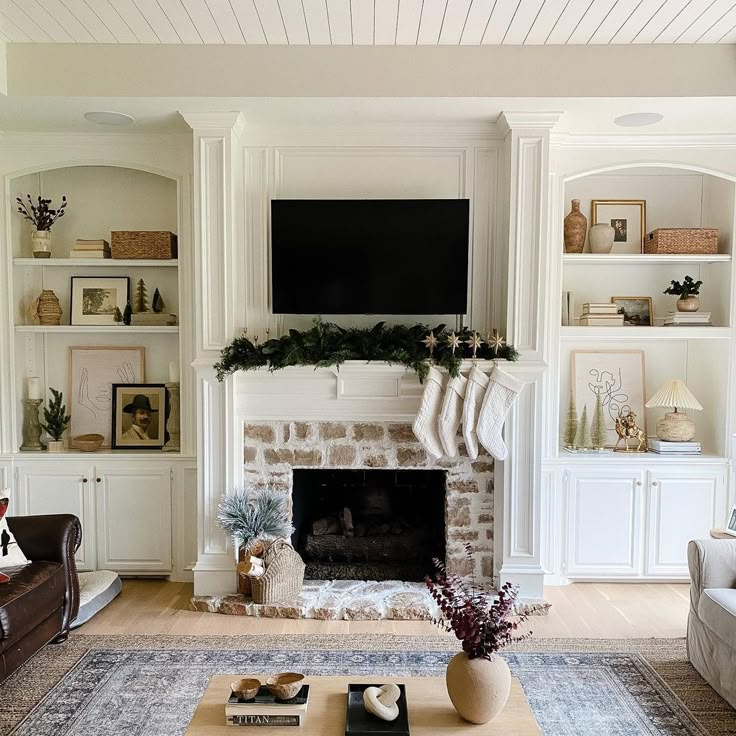 a living room filled with furniture and a flat screen tv mounted above a fire place