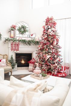 a living room decorated for christmas with red and white decor