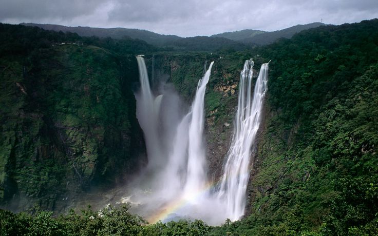 a rainbow in the middle of a waterfall