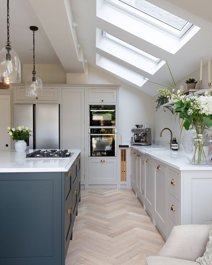 a kitchen with an oven, stove and counter tops in white and grey colors is shown