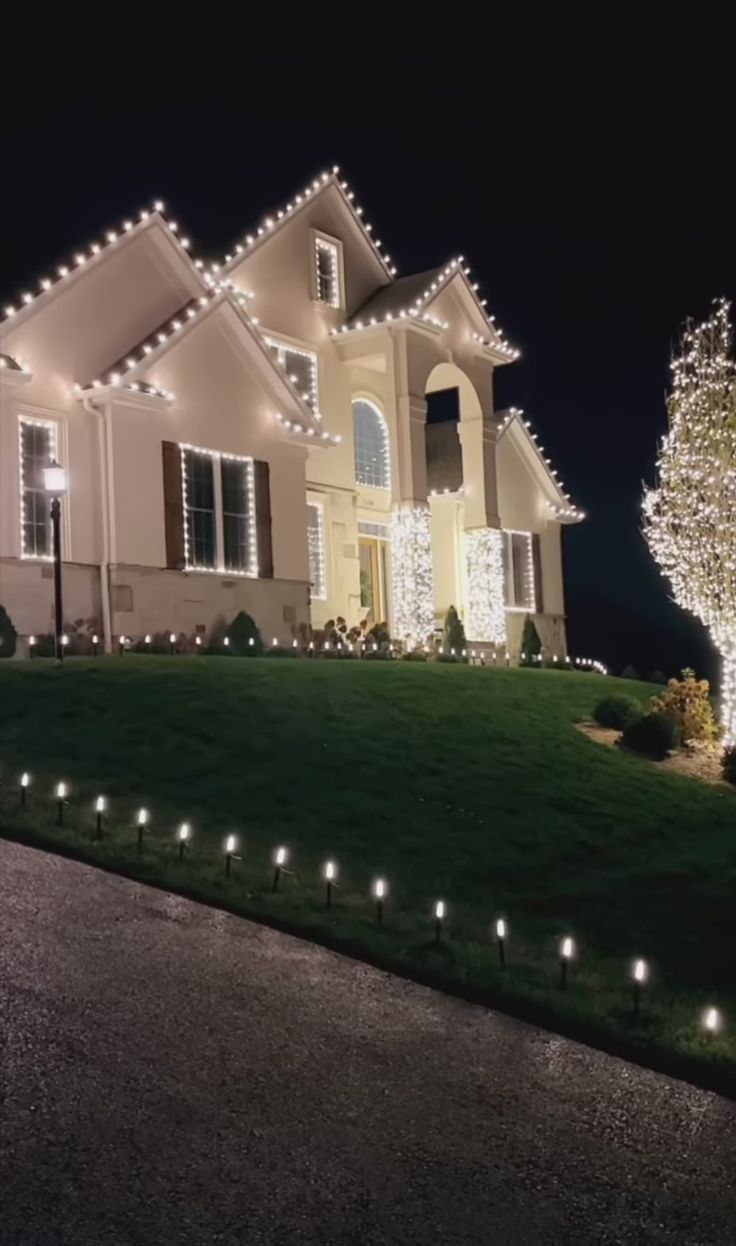 a house with christmas lights on the front lawn