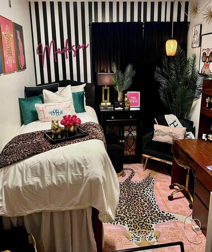 a bedroom with black and white striped walls, leopard print bedding, pink rugs, green accents