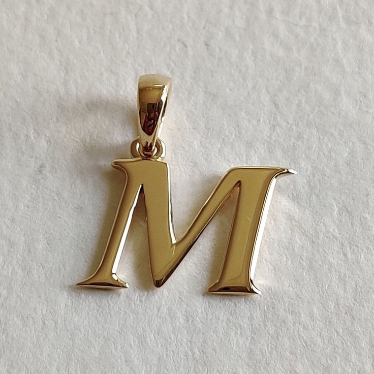 This is an exquisite initial charm pendant set in 14K Solid Gold.  An elegant design, perfect for any occassion. ITEM DETAILS: ✓ Letter : M ✓ Gold Kt: Solid 14K Yellow Gold ✓ 14 K Gold Weight : 1.51 grams ✓ Gross Weight: 1.51 grams >>The Gold purity is guaranteed and it comes with authentic 14K gold hallmark. >>A-Z letters available on my Etsy Shop. CUSTOMER SUPPORT: We are available 24/7 to respond to all your queries! PACKAGING: The pendant comes in layers of safe and secure wrapping along with a free Handmade Jewelry Box. Classic Initial Pendant Jewelry With Hallmarks, Classic Yellow Gold Initial Necklace For Anniversary, Formal Hallmarked Initial Pendant Necklace, Classic Formal Initial Necklace, Anniversary Initial Pendant Necklace With Polished Finish, Classic Monogram Initial Necklace For Anniversary, Classic Initial Necklace For Anniversary And Mother's Day, Classic Pendant Initial Necklace, Classic Initial Necklace For Anniversary With Polished Finish