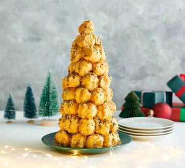 a small christmas tree made out of cookies on a plate next to plates and trees